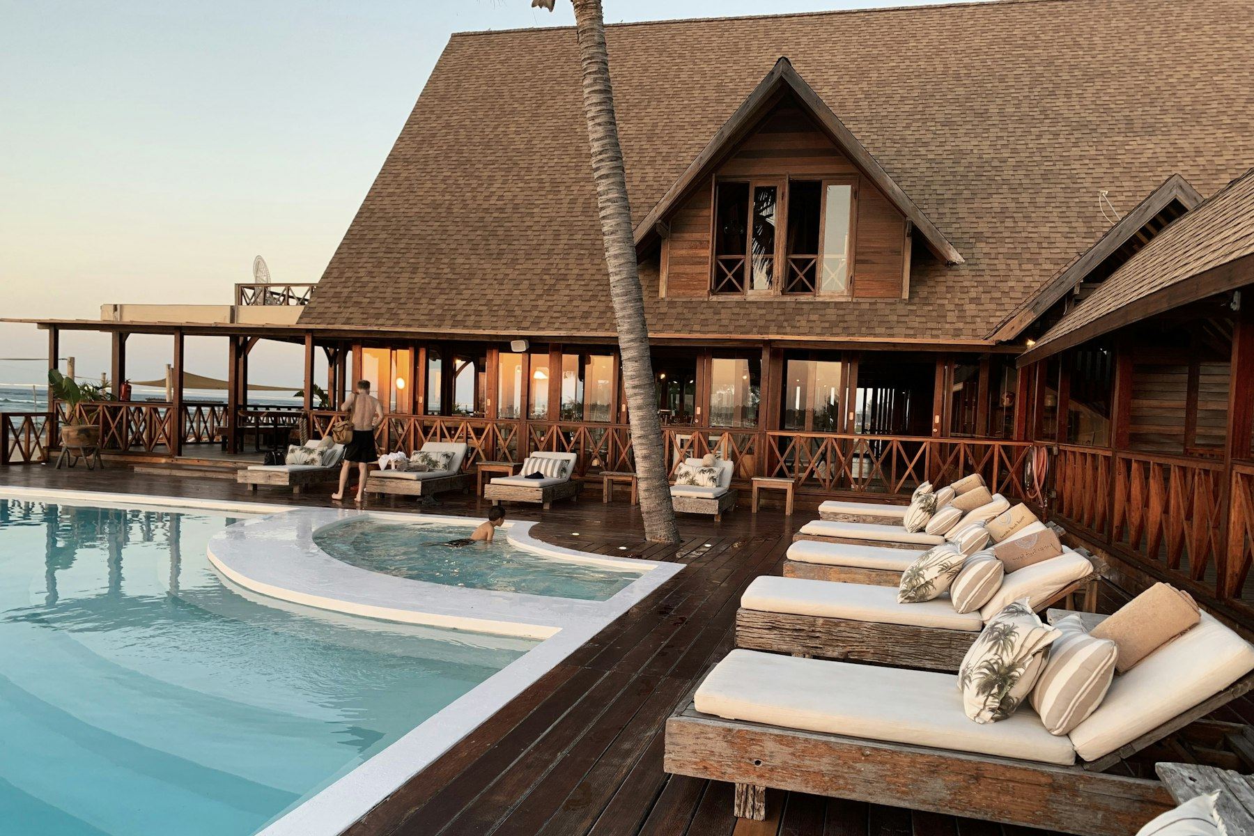 A relaxed hotel pool deck at golden hour